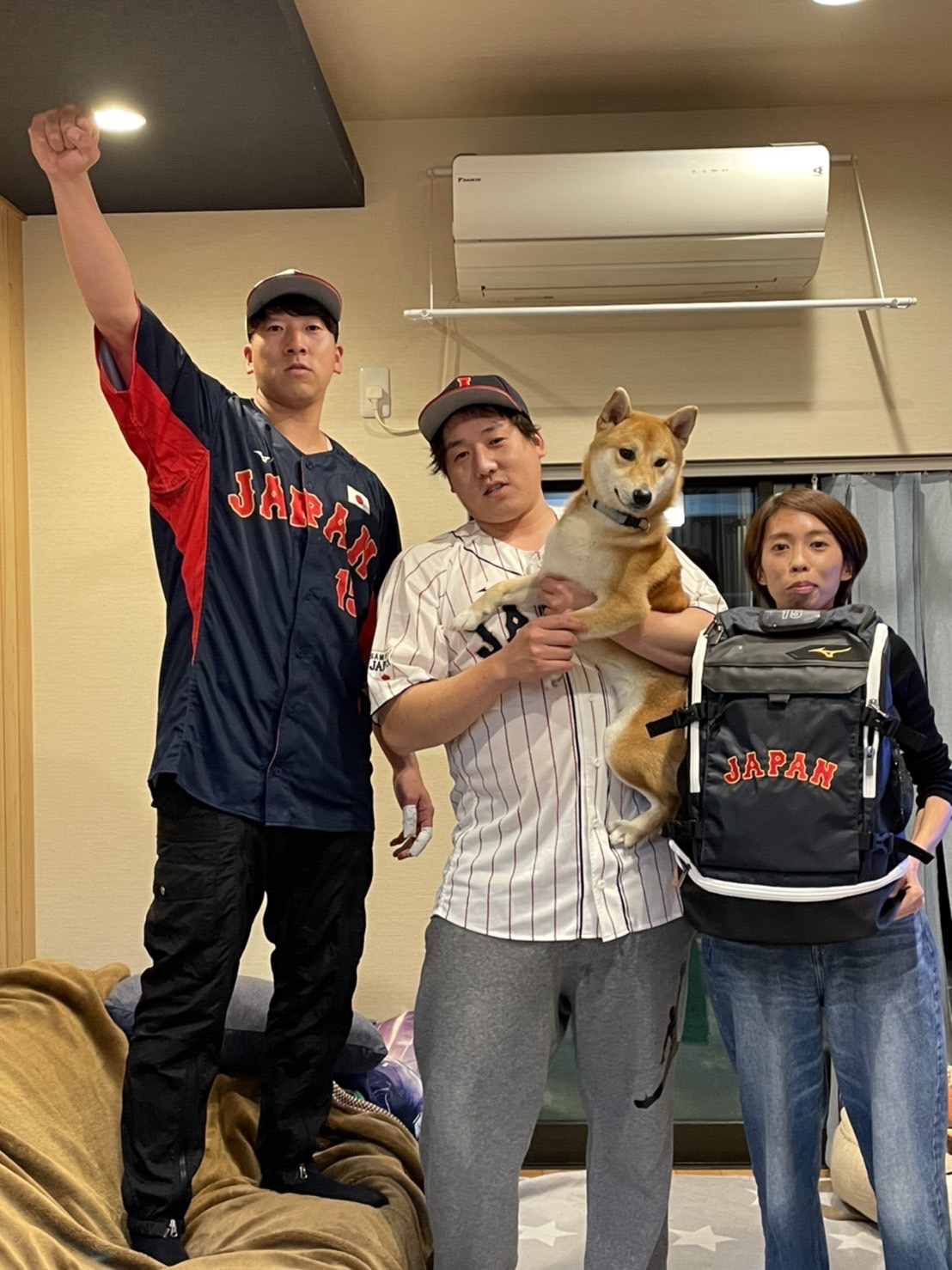 昨年11月の侍ジャパンシリーズで着用した日本代表のユニホームとリュックを着て記念撮影する翁田3きょうだい。左から巨人大勢、兄勝基さん、姉あかりさん（母いずみさん提供）