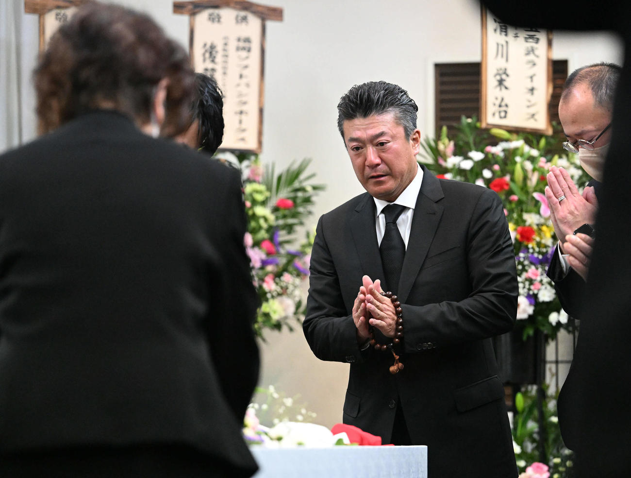 入来智さんの葬儀・告別式で棺に手を合わせる弟のオリックス祐作投手コーチ（撮影・滝沢徹郎）