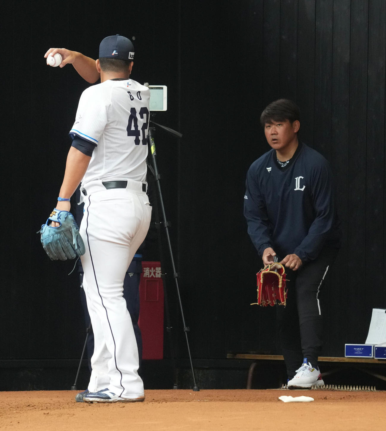 ブルペンで投球する西武ボー（左）に声を掛ける臨時コーチの松坂氏（撮影・小沢裕）