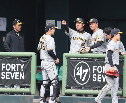 楽天対阪神　6回裏を終えベンチに戻った右翼手森下（右から3人目）は筒井外野守備走塁コーチと守備を確認する。左は岡田監督（撮影・上山淳一）