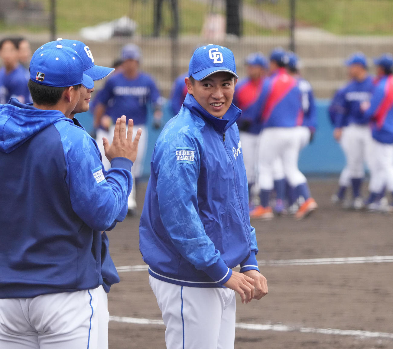中日2軍練習試合　中日対沖縄電力　試合終了、ナインを迎える仲地（右）（撮影・森本幸一）