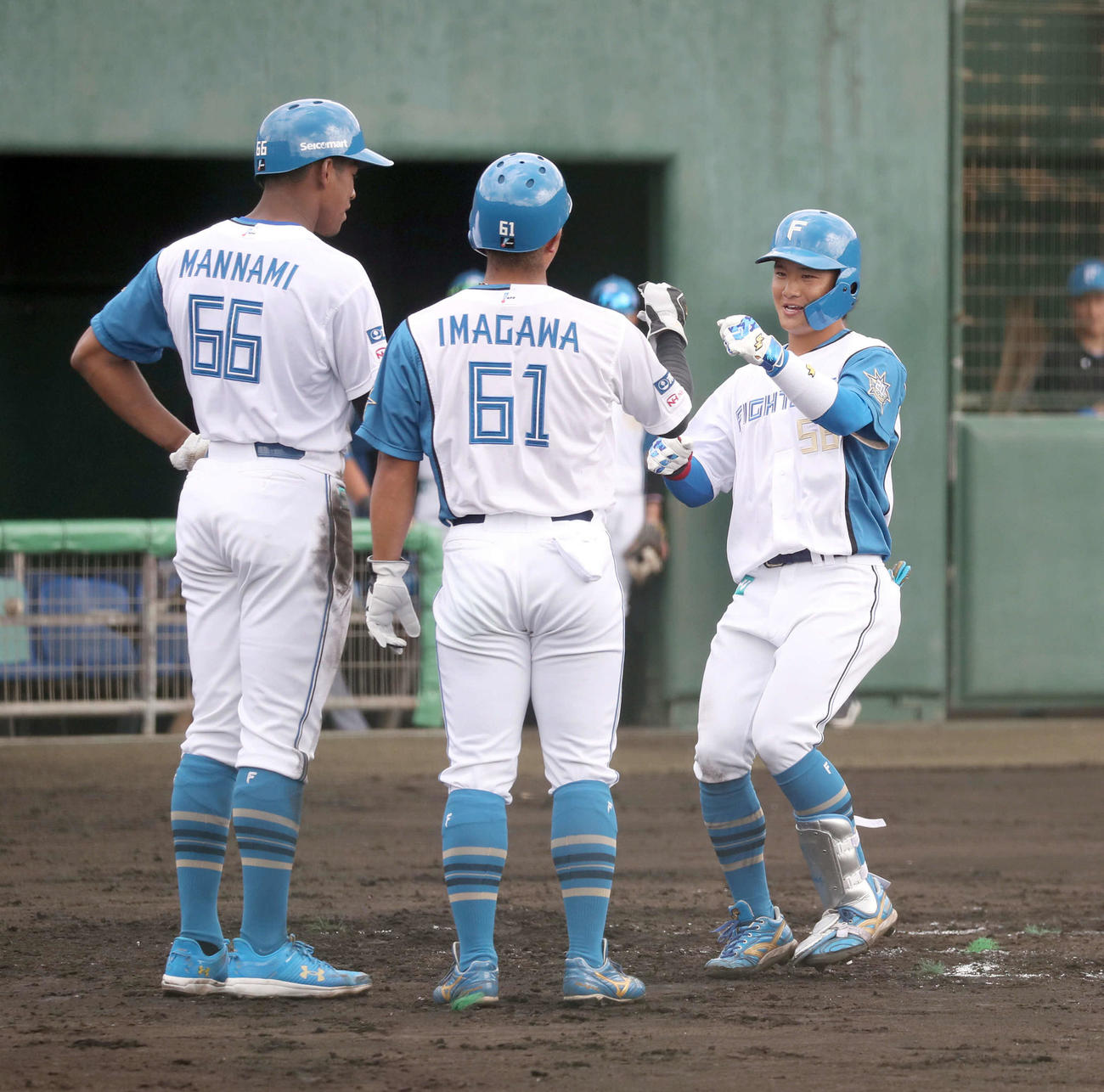 日本ハム対サムスン2回裏日本ハム1死一、二塁、逆転となる右越え3点本塁打を放ち万波（左）と今川（中央）に出迎えられる奈良間（撮影・佐藤翔太）