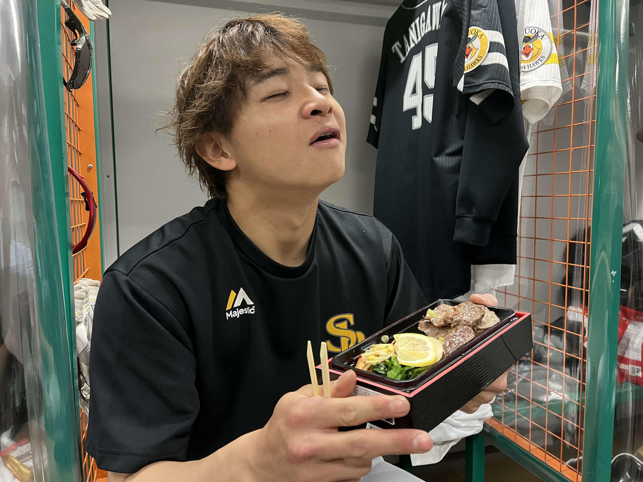 牛乃屋の弁当をおいしそうに食べるソフトバンク谷川原（球団提供）