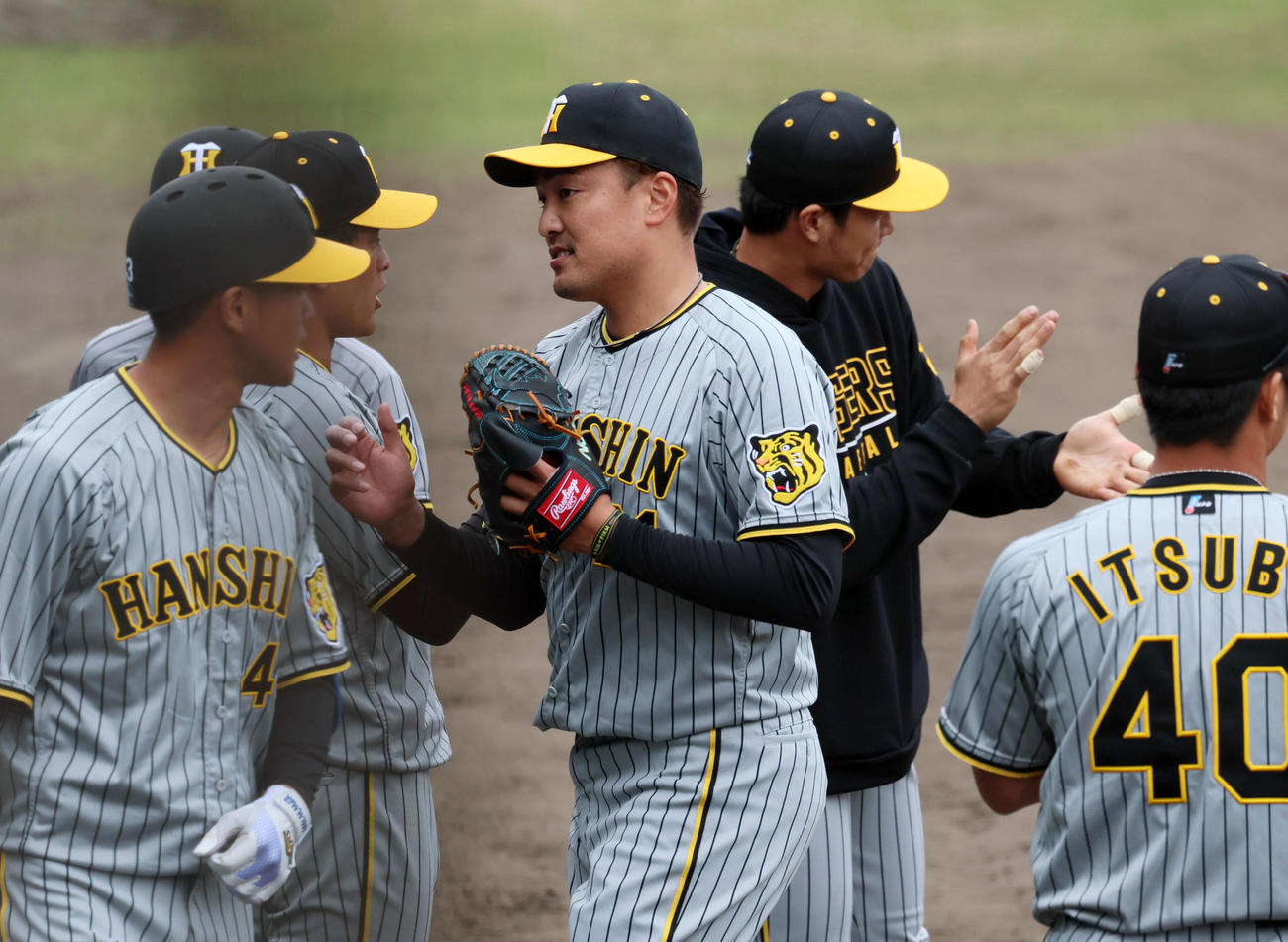 中日対阪神　1回裏を投げ終えベンチ前でナインとタッチする先発の秋山（撮影・加藤哉）