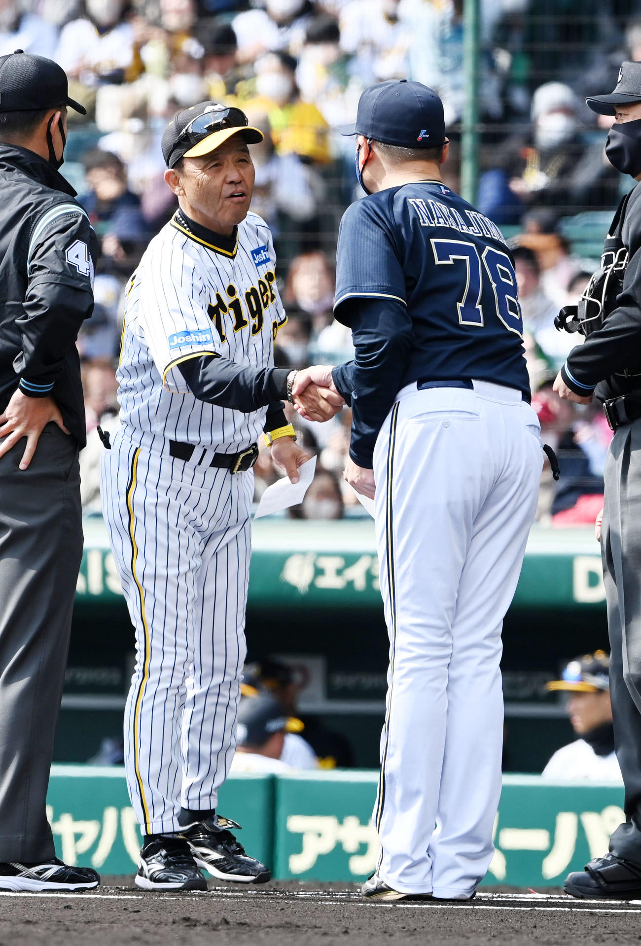 阪神対オリックス　オリックス中嶋監督（右）とメンバー表を交換する阪神岡田監督（撮影・前岡正明）