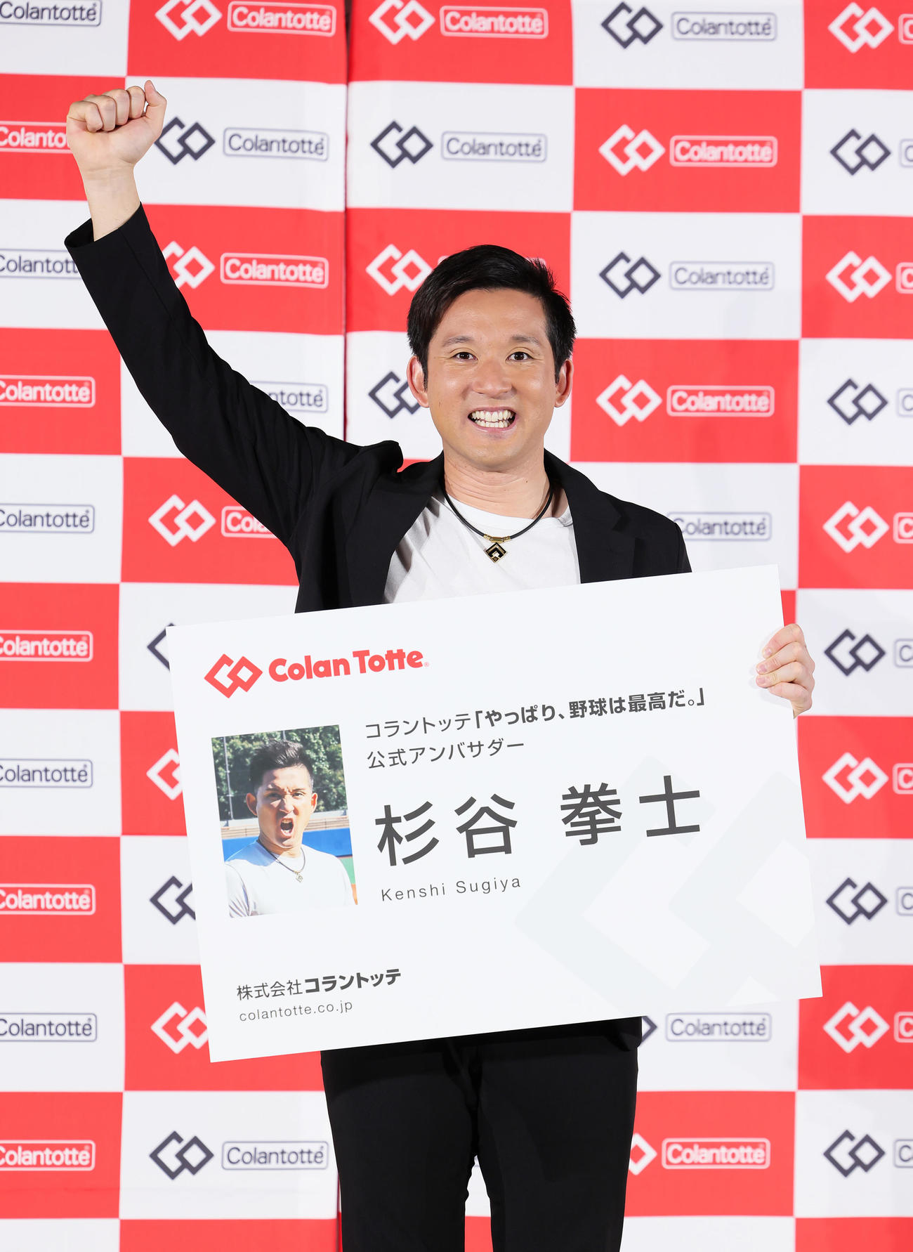 就任式で巨大名刺を手に笑顔を見せる杉谷氏（撮影・足立雅史）