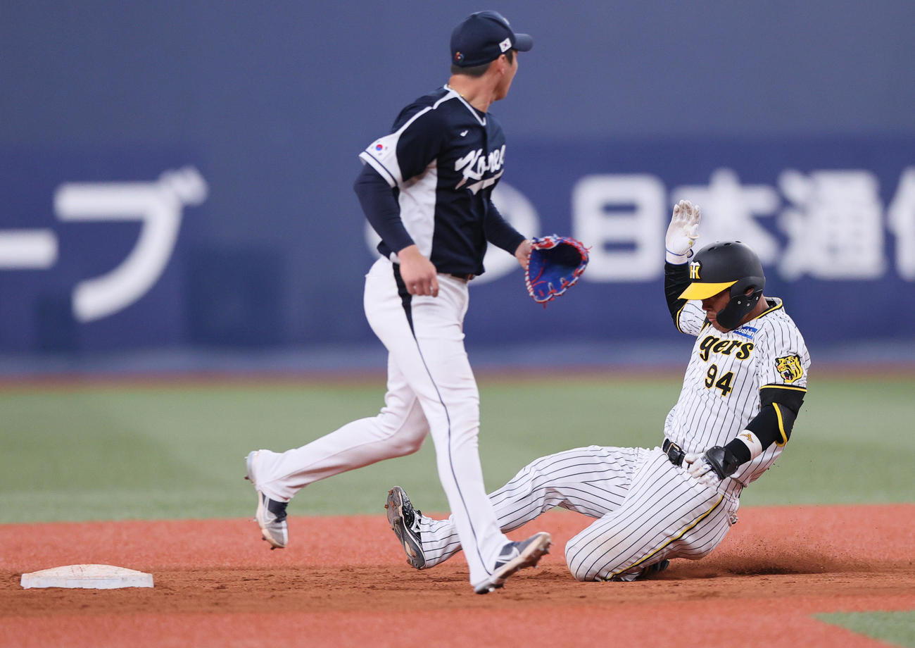 阪神対韓国　8回裏阪神無死、原口（右）は右へ二塁打を放ち二塁に向かう（撮影・上山淳一）
