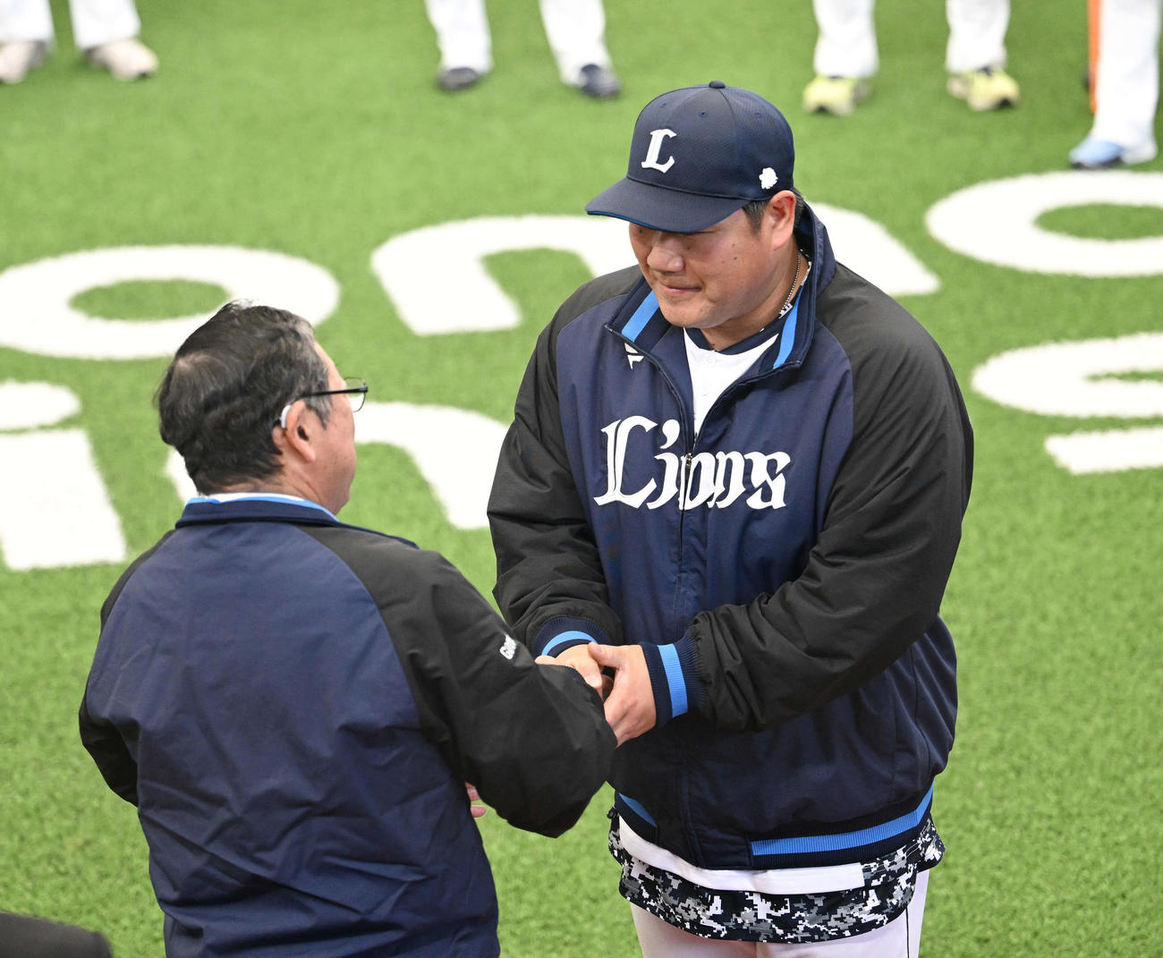 西武対中日　訓示を終えた株式会社西武ライオンズ取締役オーナーの後藤氏（左）は中村と握手を交わす（撮影・滝沢徹郎）