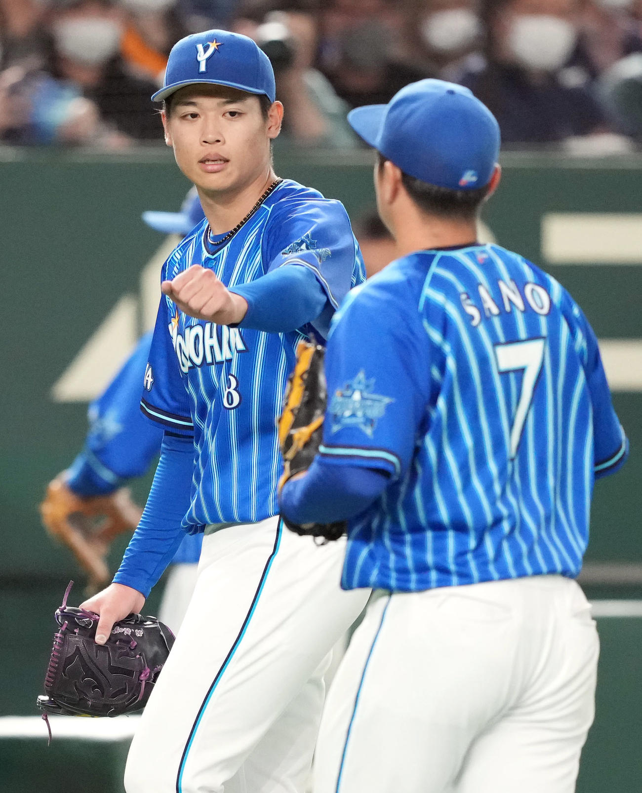 巨人対DeNA 5回裏を抑え、佐野（手前）とタッチを交わすDeNA先発の小園（撮影・狩俣裕三）