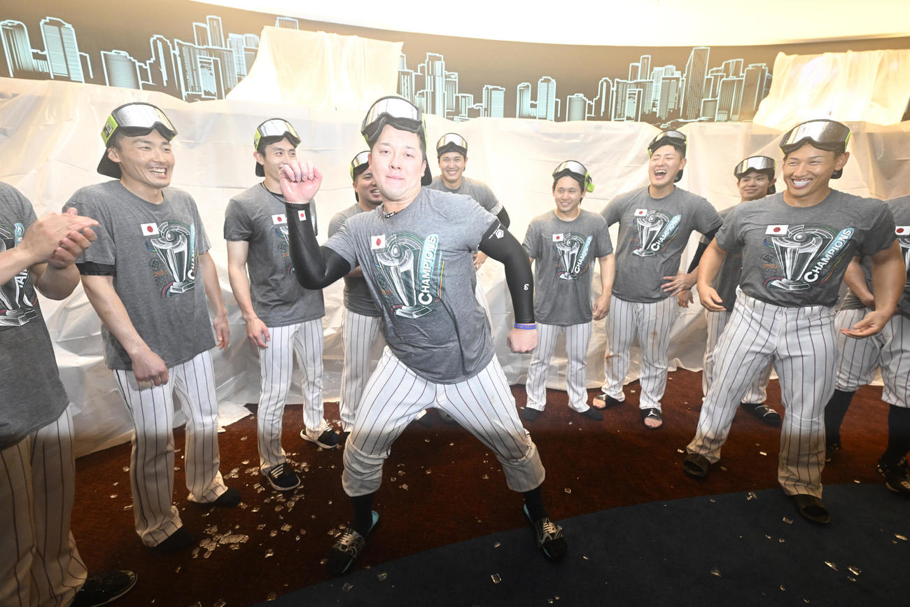 試合後のシャンパンファイトでなぞのダンスを披露する牧（中央）と見つめる選手たち。左から源田、周東、山川、1人おいて大谷、宮城、岡本、中野、吉田