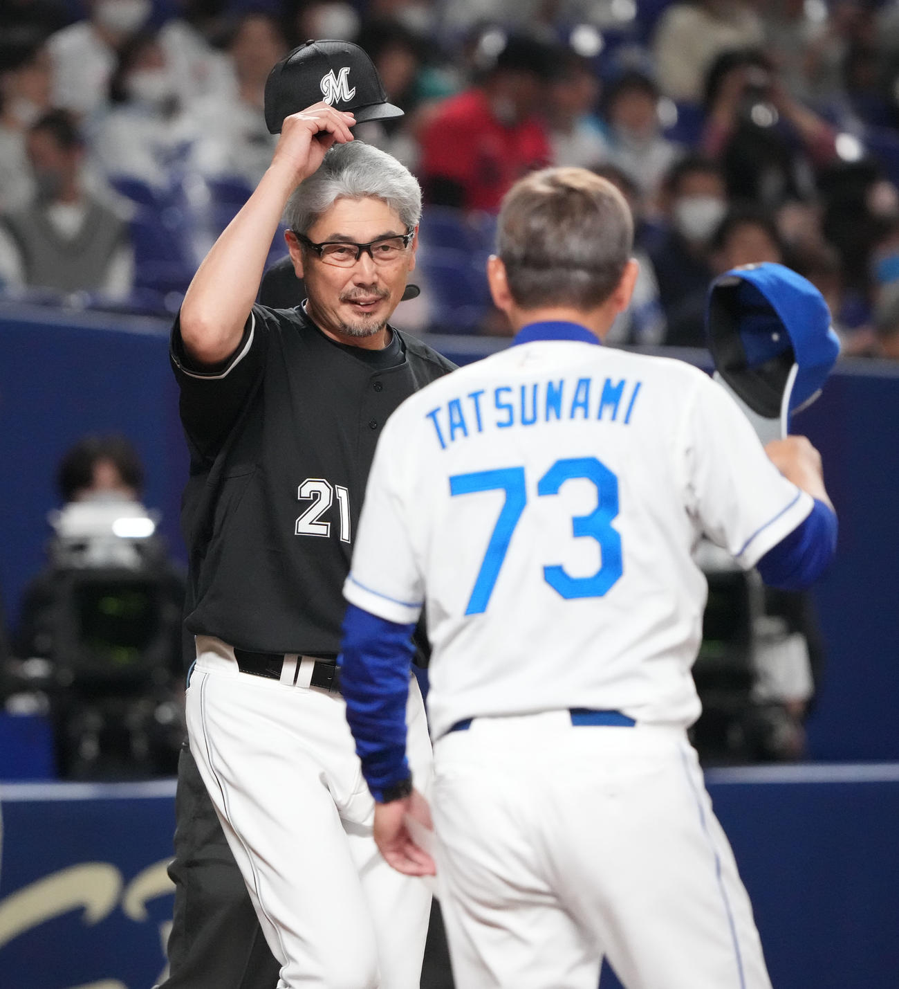 中日対ロッテ戦　立浪監督とメンバー表を交換するロッテ吉井監督（左）（撮影・森本幸一）