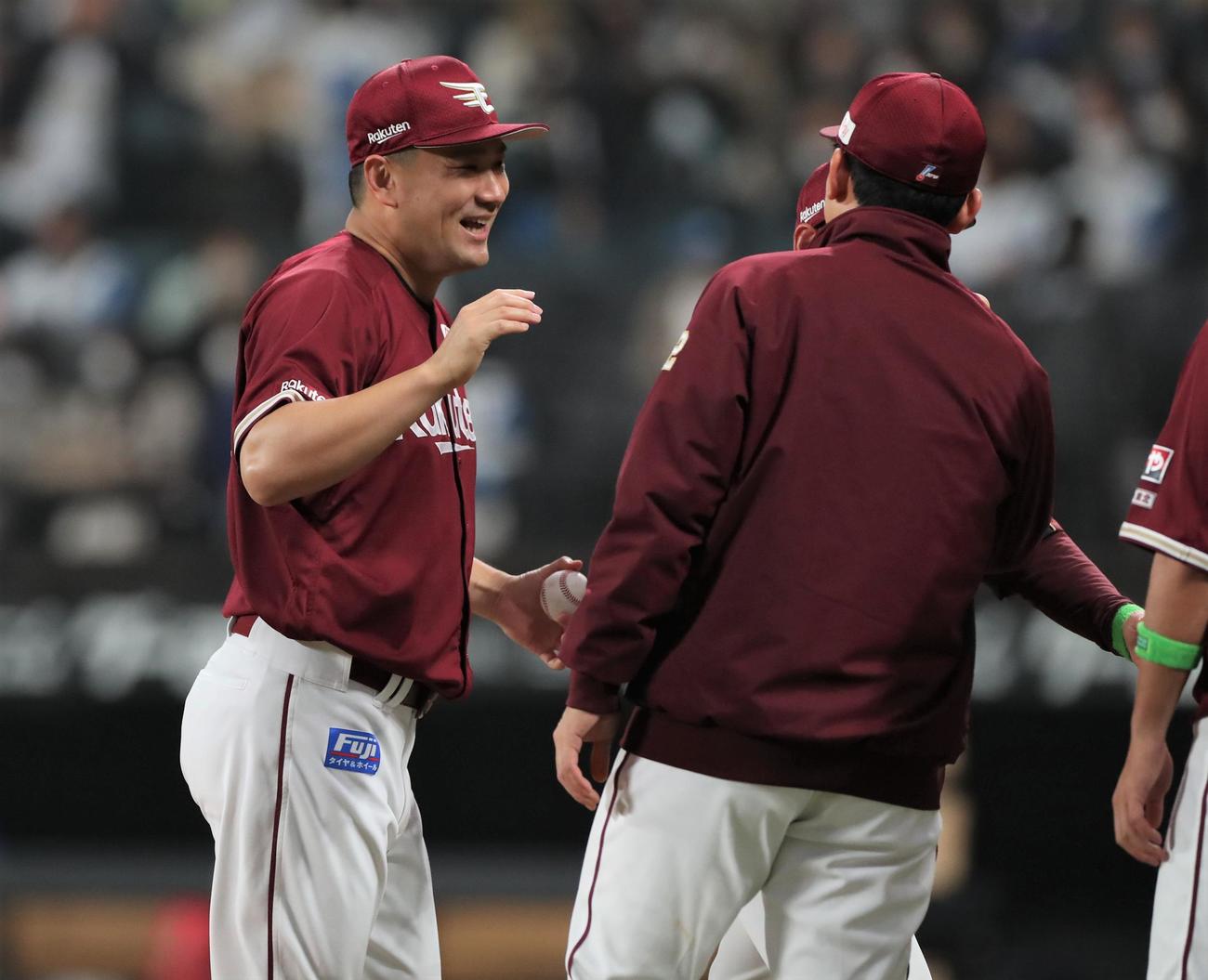 日本ハム対楽天　開幕勝利を挙げ笑顔でナインとタッチする田中将（撮影・黒川智章）