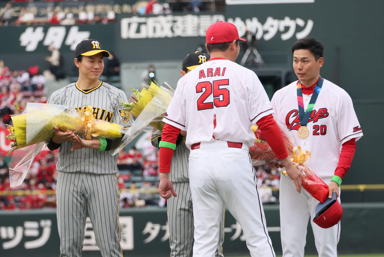 広島対阪神　栗林（右から2人目）に金メダルを渡す新井監督。左は湯浅（撮影・加藤孝規）