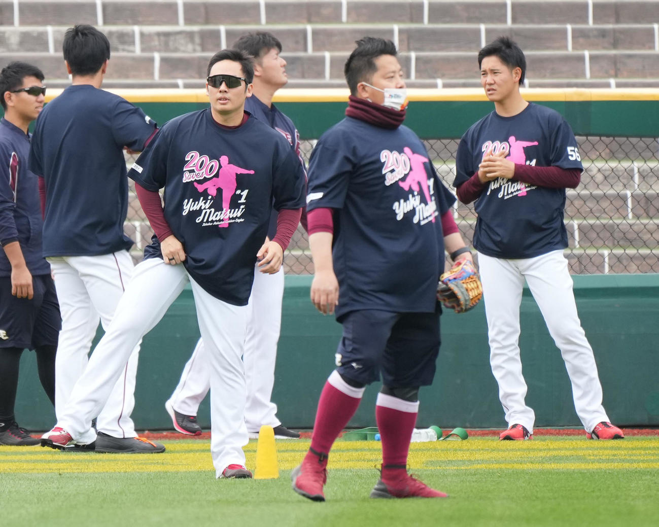 楽天対西武　前日の試合で史上最年少でプロ入り通算200セーブを達成した楽天松井裕（左）は記念Tシャツを着て祝福するナインや関係者に囲まれて試合前練習に臨む（撮影・小沢裕）