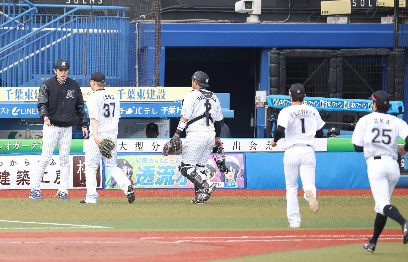 ロッテ対日本ハム　7回表を終え、ナインを迎える佐々木朗（左）（撮影・河田真司）