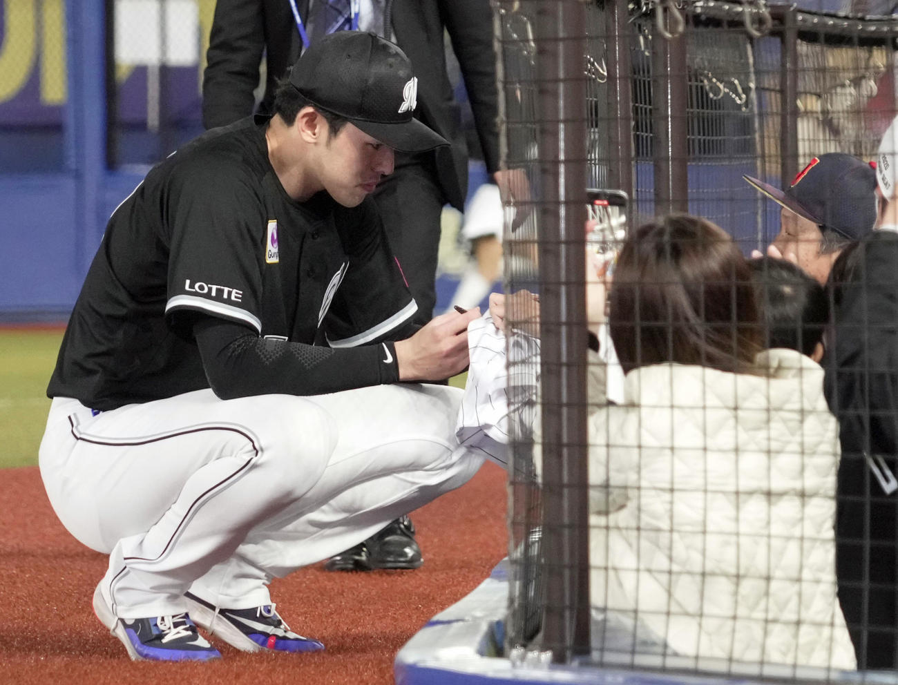 2勝目を挙げ、ファンにサインするロッテ・佐々木朗希（共同）