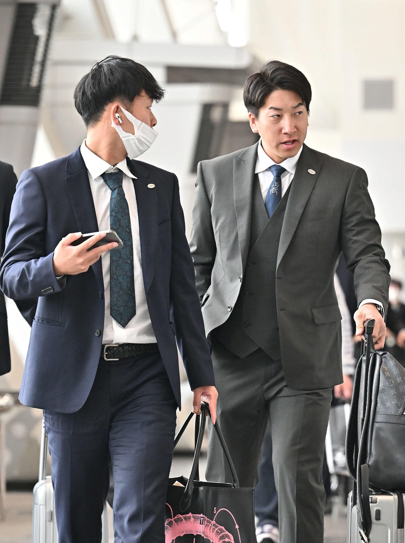佐賀から帰京する巨人山崎伊（左）と大勢（撮影・滝沢徹郎）