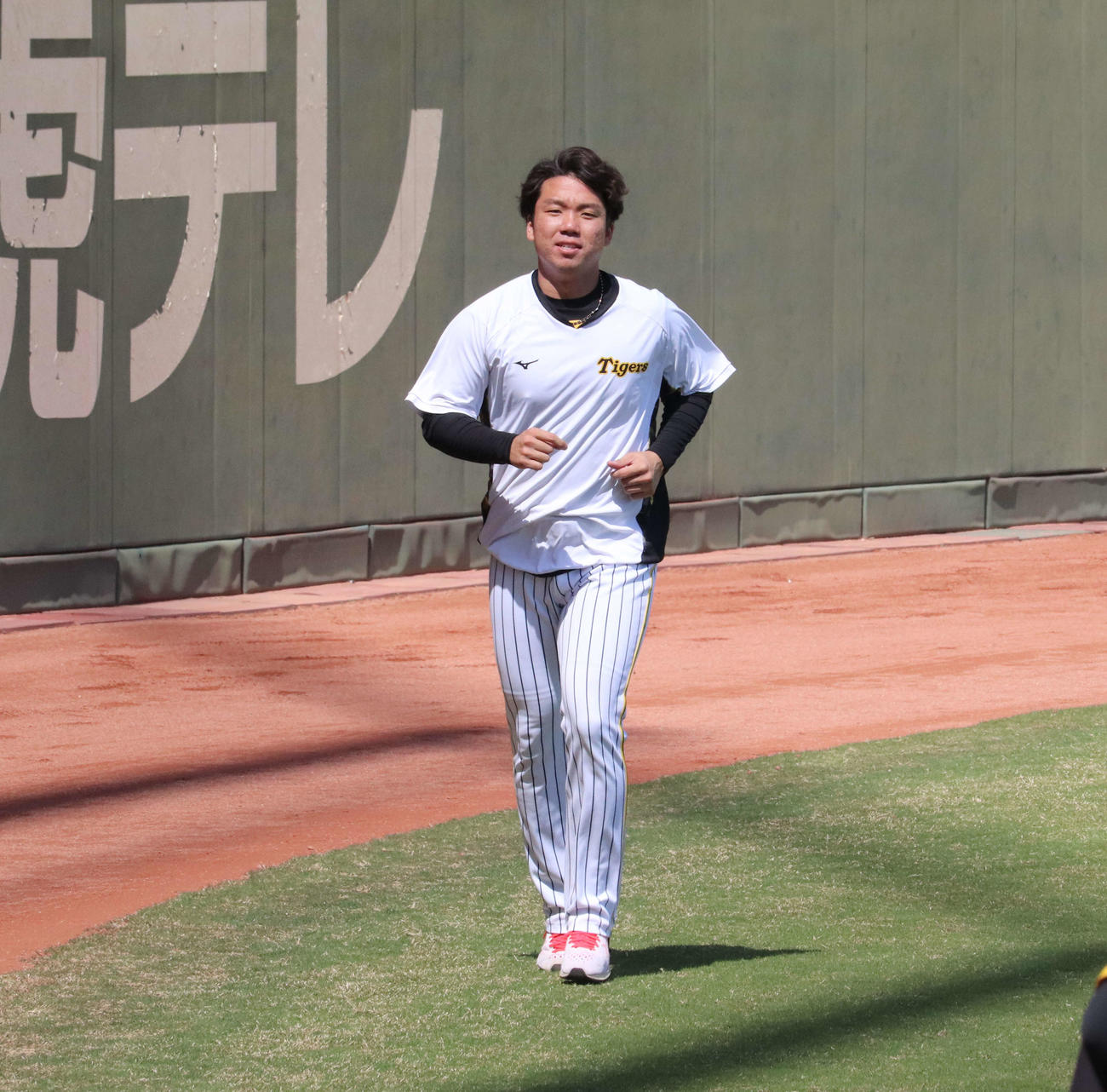プロ初勝利から一夜明け、鳴尾浜球場で体を動かす阪神村上（撮影・三宅ひとみ）