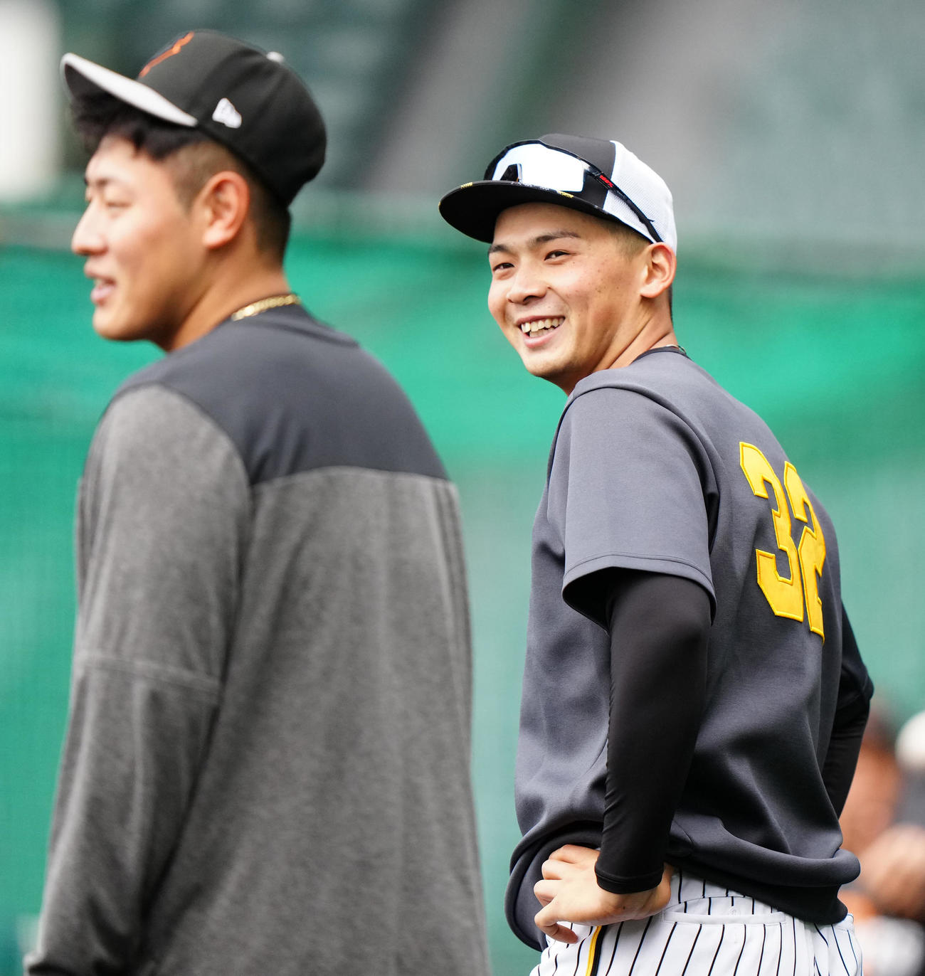 阪神対巨人　試合前、巨人岡本和（左）と言葉を交わす阪神井上（撮影・江口和貴）