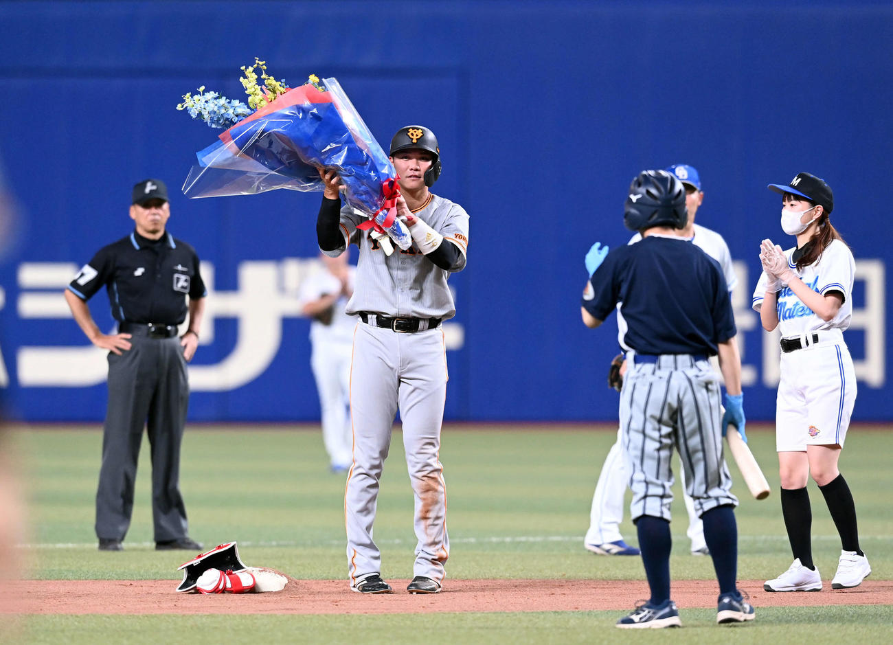 中日対巨人　7回表巨人2死、通算3500塁打を上回りベース上で花束を贈られる坂本（撮影・たえ見朱実）