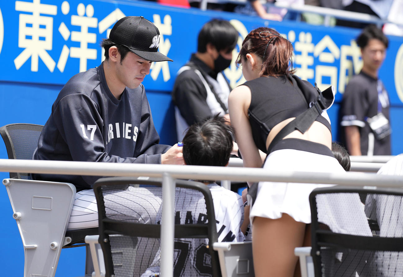 ロッテ対ソフトバンク　試合前、子供にサインするロッテ佐々木朗（撮影・鈴木みどり）