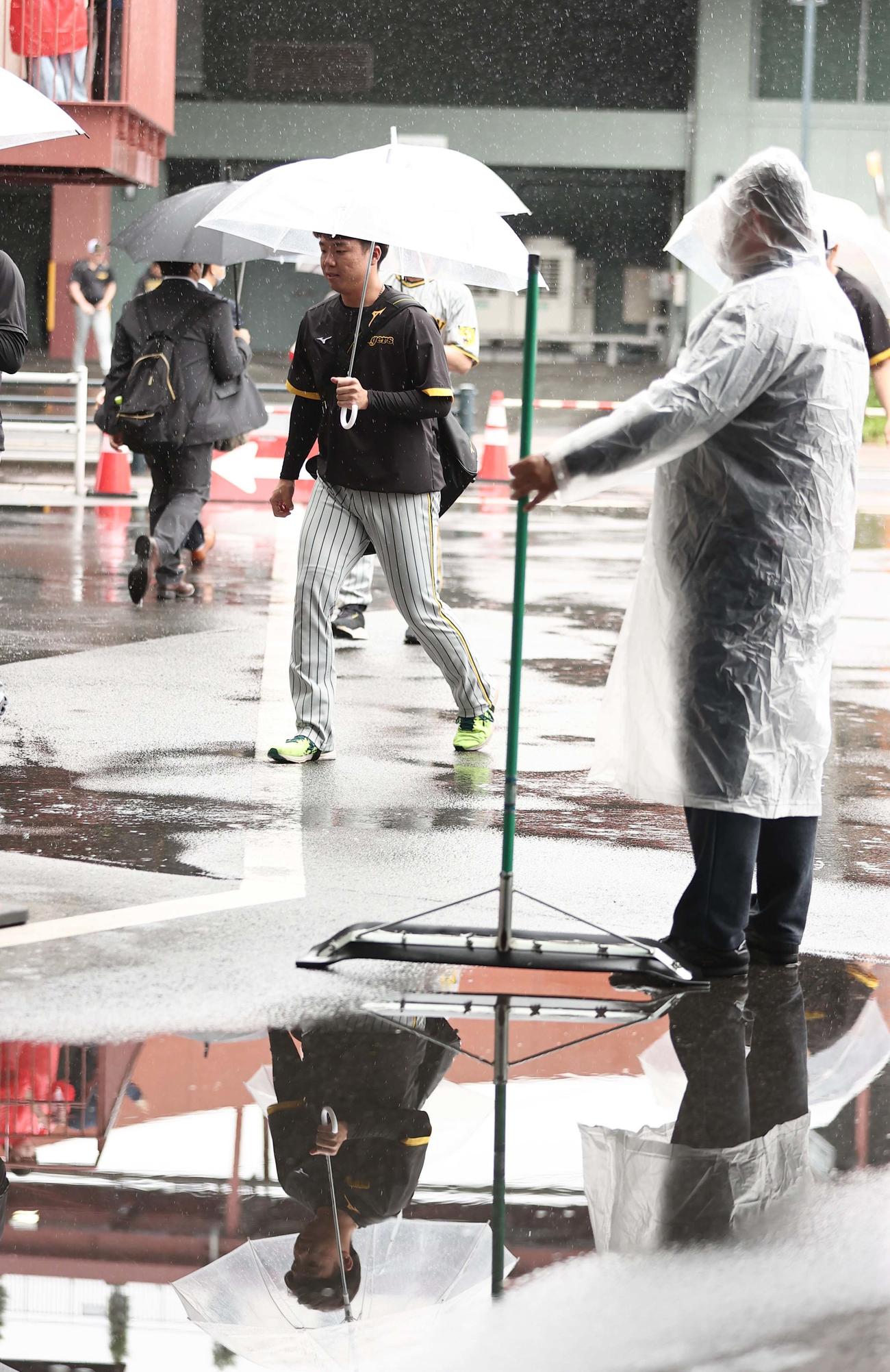 雨の中、室内練習場へ向かう村上（撮影・上田博志）