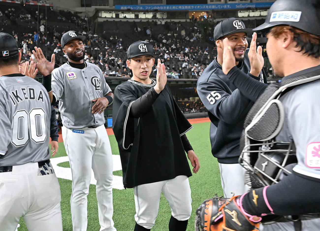 西武対ロッテ　試合に勝利しチームメートとタッチをかわすロッテ小島（中央）（撮影・滝沢徹郎）