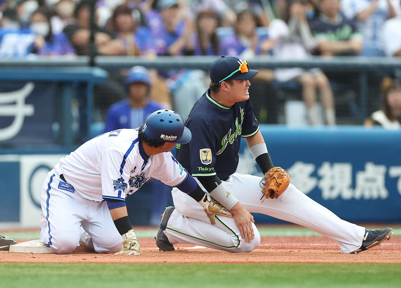 DeNA対ヤクルト　3回裏DeNA2死一塁、牧の左前打で三塁進塁するDeNA宮崎（左）と膝を押さえる村上（撮影・河田真司）