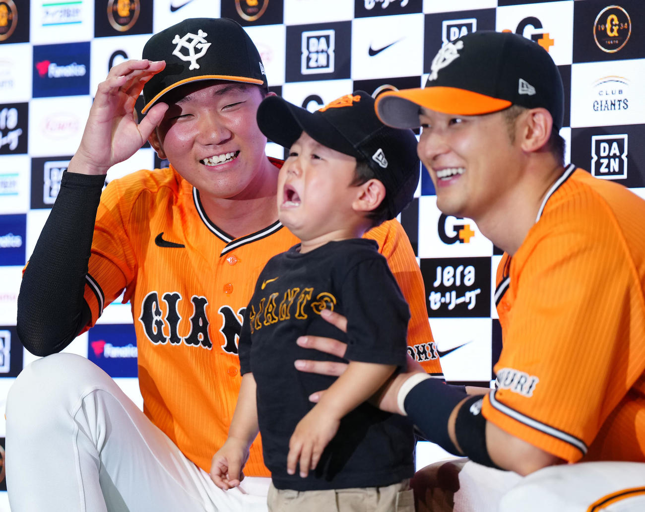 巨人対DeNA　試合後、ファンとの記念撮影で男の子が泣き、笑顔を見せる巨人田中千。右は吉川（撮影・江口和貴）