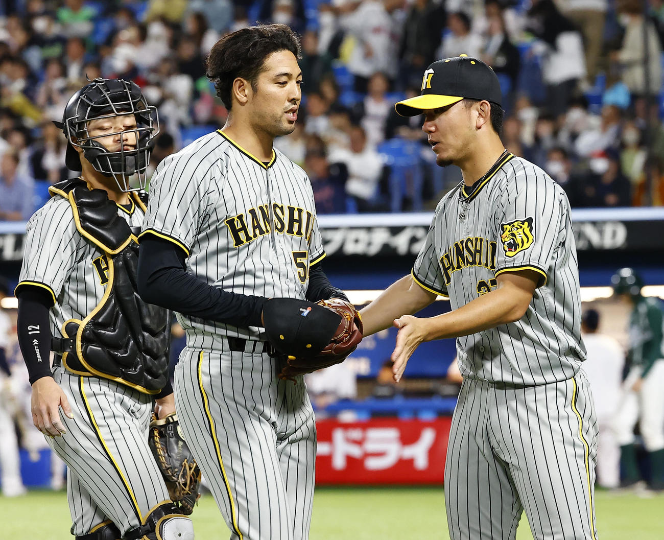 阪神対ヤクルト　8回裏を終え加治屋（中央）を迎える阪神伊藤将（撮影・藤尾明華）