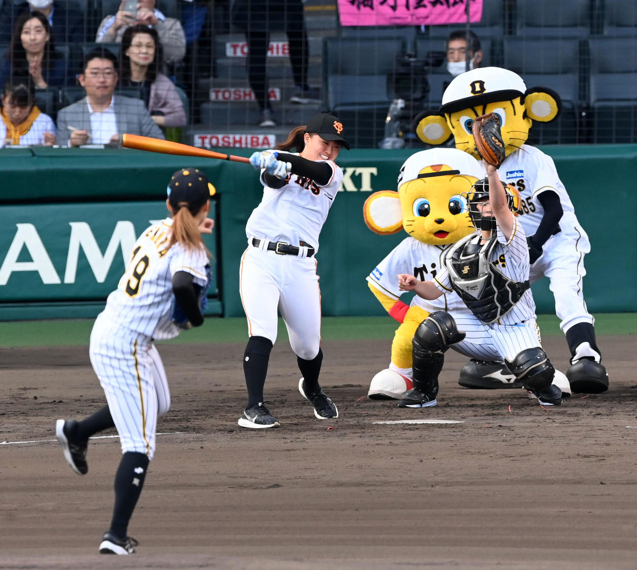 阪神対巨人　ファーストピッチセレモニーを行った、阪神タイガースWomen植村と安藤蓮姫のバッテリー。打者はジャイアンツ女子チーム島野（撮影・前岡正明）