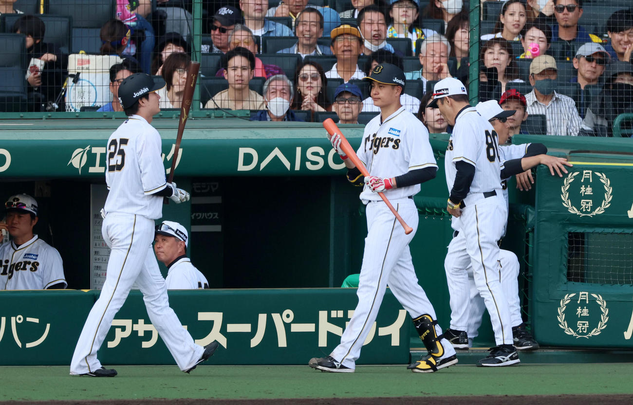 阪神対巨人　7回裏阪神2死二塁、打席へ向かう大竹（右）に代打を告げる岡田監督。左は渡辺諒（撮影・加藤哉）