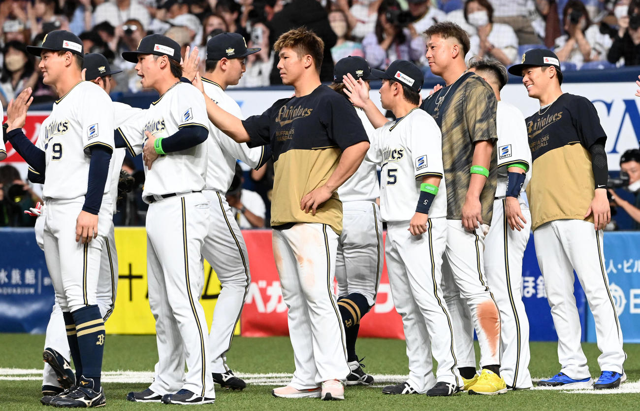 オリックス対広島　勝利投手の山本（右）は笑顔でナインを迎える（撮影・前岡正明）