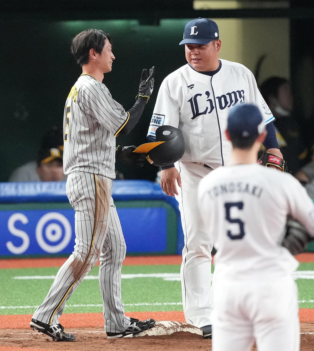 西武対阪神　5回表阪神2死一塁、打者中野の時、けん制で帰塁した際、痛めた一塁走者近本に声をかける一塁手渡部（撮影・鈴木みどり）