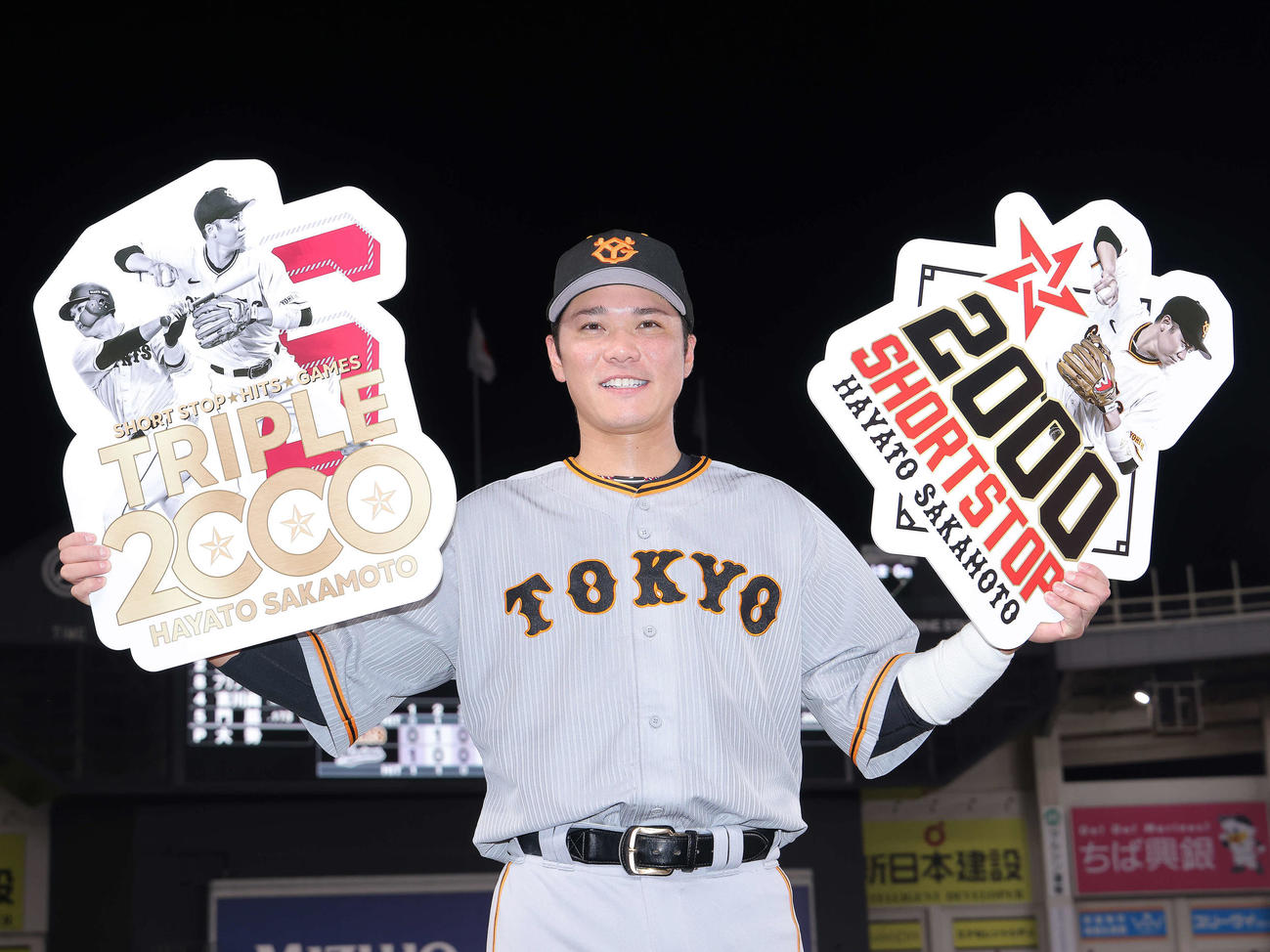 ロッテ対巨人　遊撃手での通算2000試合出場を達成し、記念ボードを手に笑顔を見せる巨人坂本（撮影・河田真司）