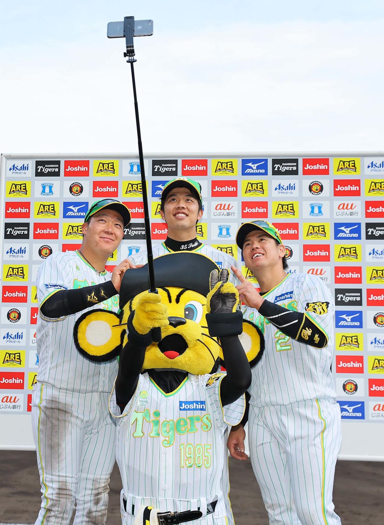 ヒーローの左から大山、才木、梅野はトラッキーと記念撮影をする（撮影・上田博志）