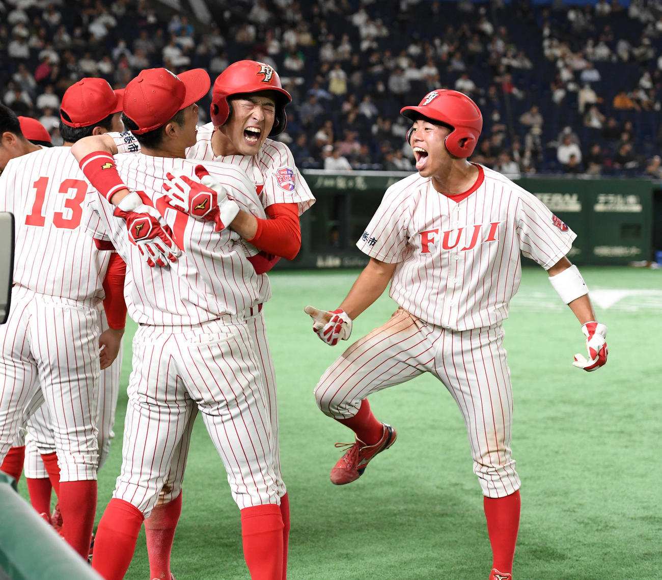 創価大対富士大　7回裏富士大1死一、二塁、渡辺陸の右越え三塁打で赤瀬（中央）、山沢（右）が同点の生還した大喜びする（撮影・柴田隆二）