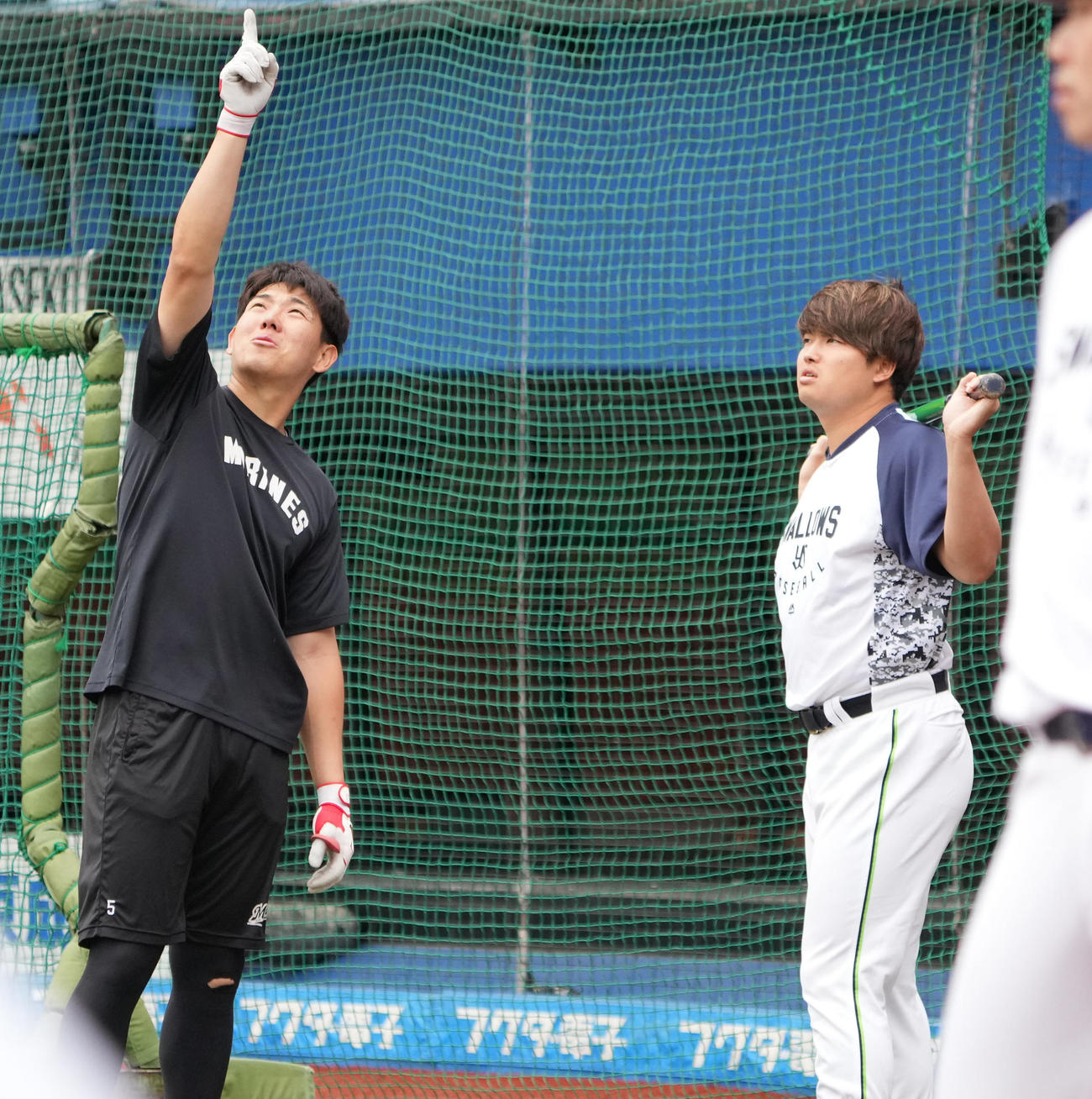 ロッテ対ヤクルト　試合前の練習で談笑するロッテ安田（左）とヤクルト村上（撮影・小沢裕）
