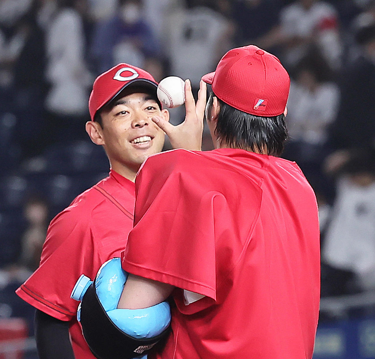 ロッテ対広島　8回を1失点で5勝目を挙げた広島床田（右）は秋山から勝利球を受け取る（撮影・足立雅史）