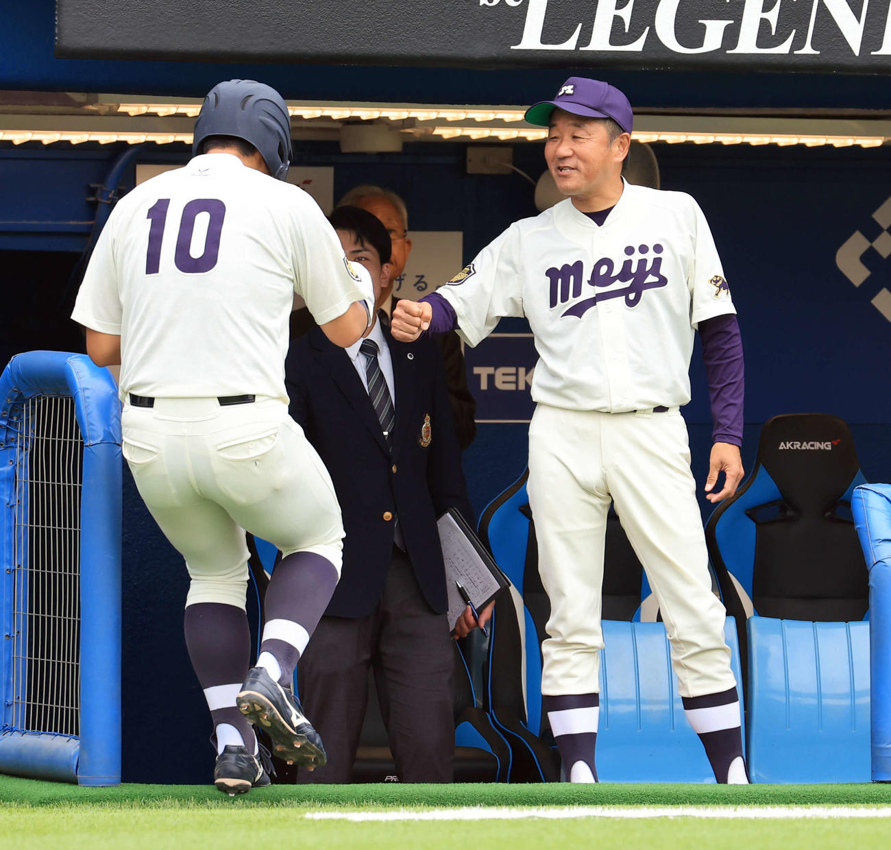 明大対白鴎大　4回表明大1死二塁、木本の中越え先制適時二塁打で、生還した上田（左）をグータッチで迎える田中監督（撮影・浅見桂子）