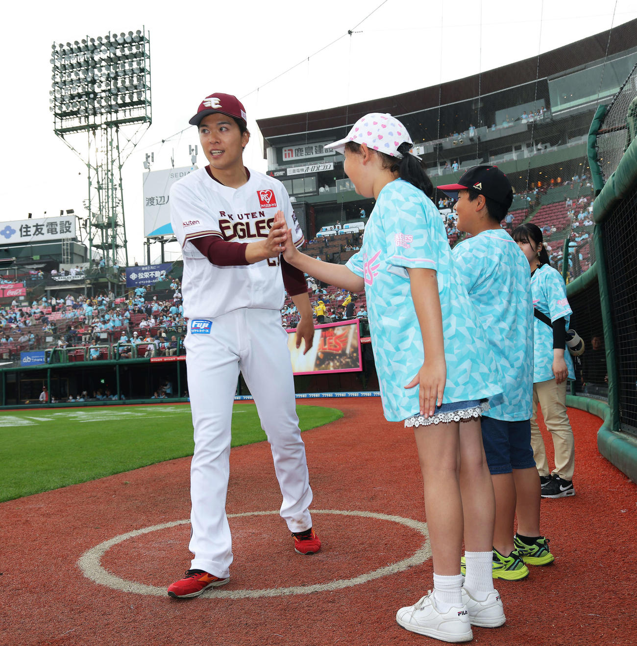 楽天対中日　中日に勝利し、試合後に子どもたちとタッチを交わしながら引き揚げる早川（撮影・河田真司）