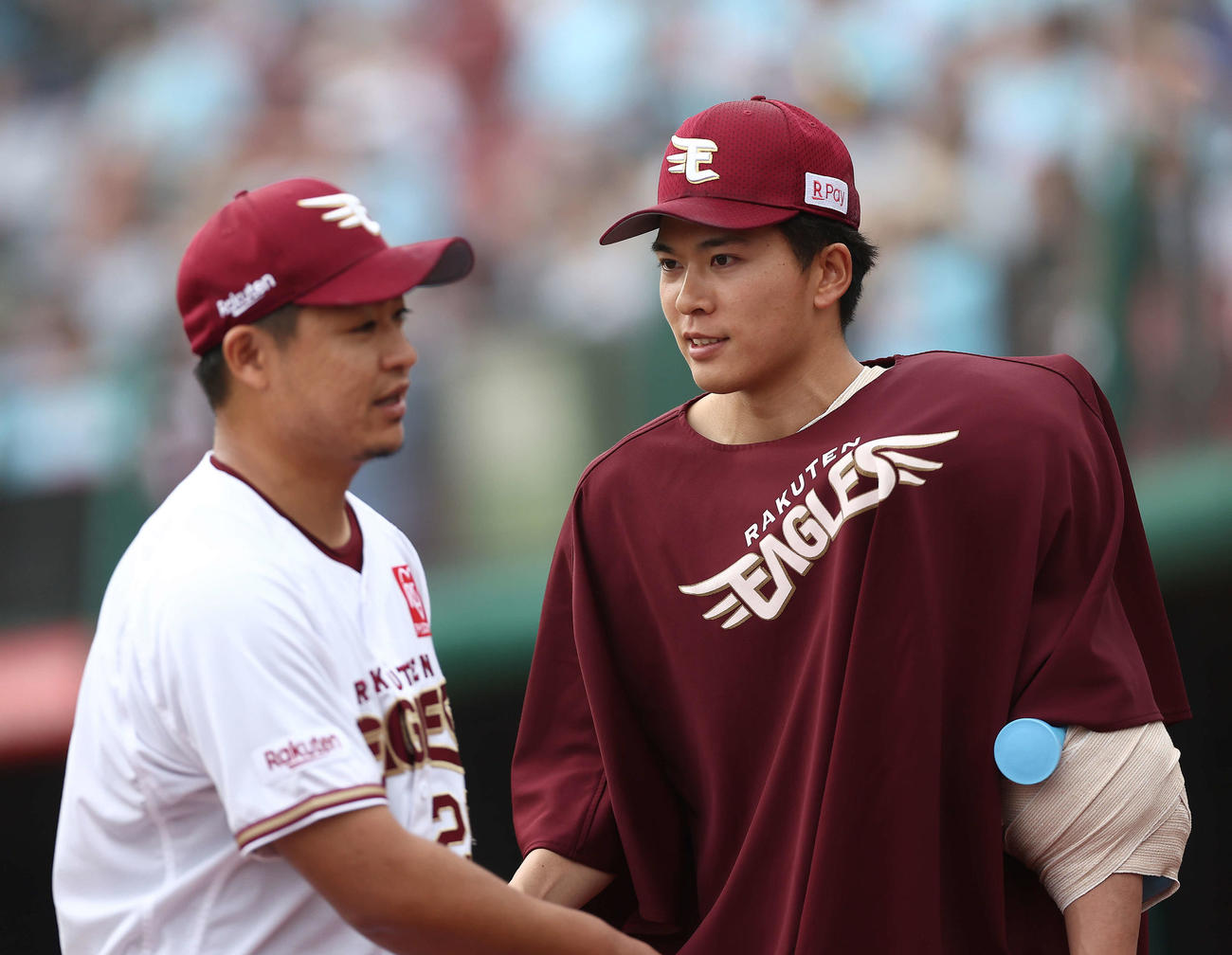 楽天対中日　8回表を抑え、ベンチに戻る酒居（左）を迎える早川（撮影・河田真司）