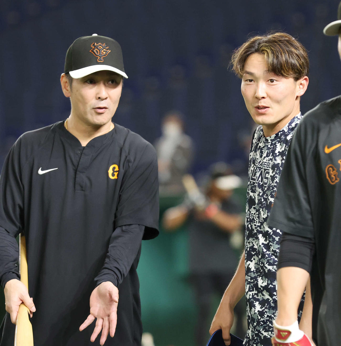 巨人対西武　試合前、巨人元木作戦兼内野守備コーチ（左）と会話を交わす西武源田（撮影・宮地輝）