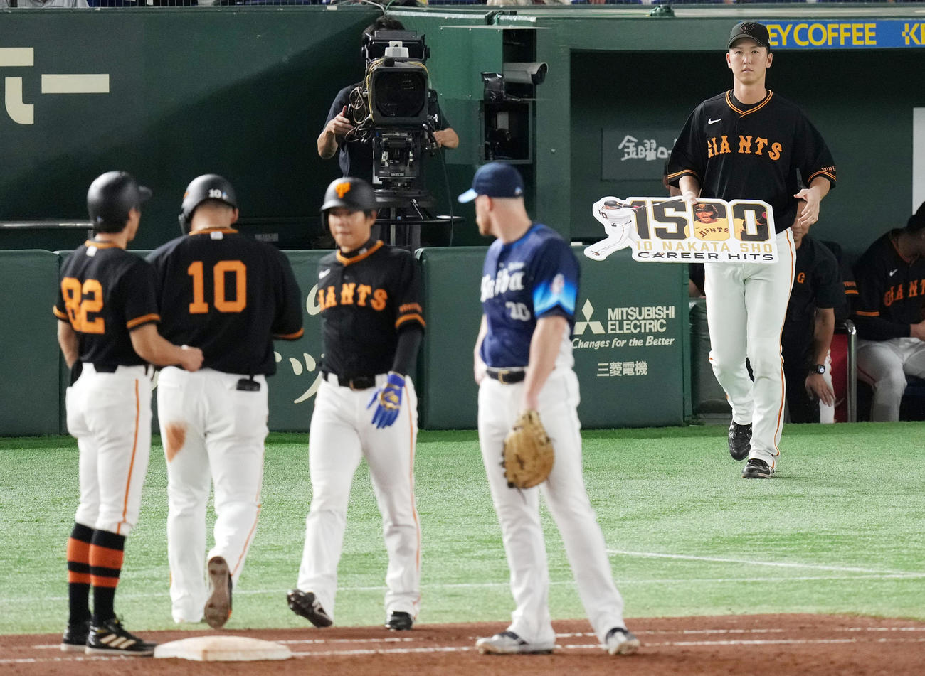 巨人対西武　7回裏巨人1死、二塁強襲内野安打で1500安打を達成した中田へボードを渡しに向かう秋広（右）（撮影・横山健太）