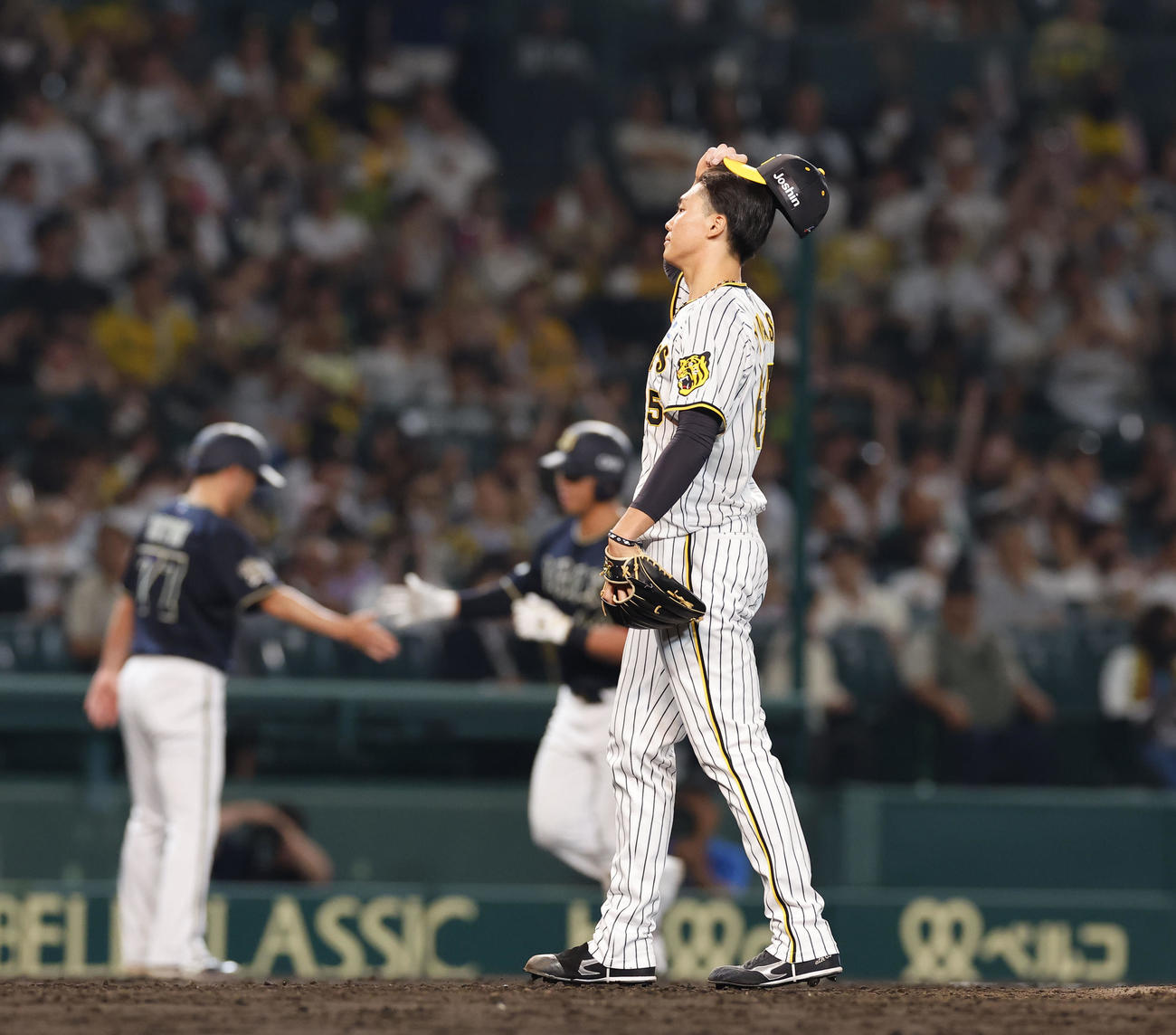 阪神対オリックス　9回表オリックス1死、頓宮（奥右）に同点本塁打を浴び、肩を落とす阪神湯浅（撮影・藤尾明華）