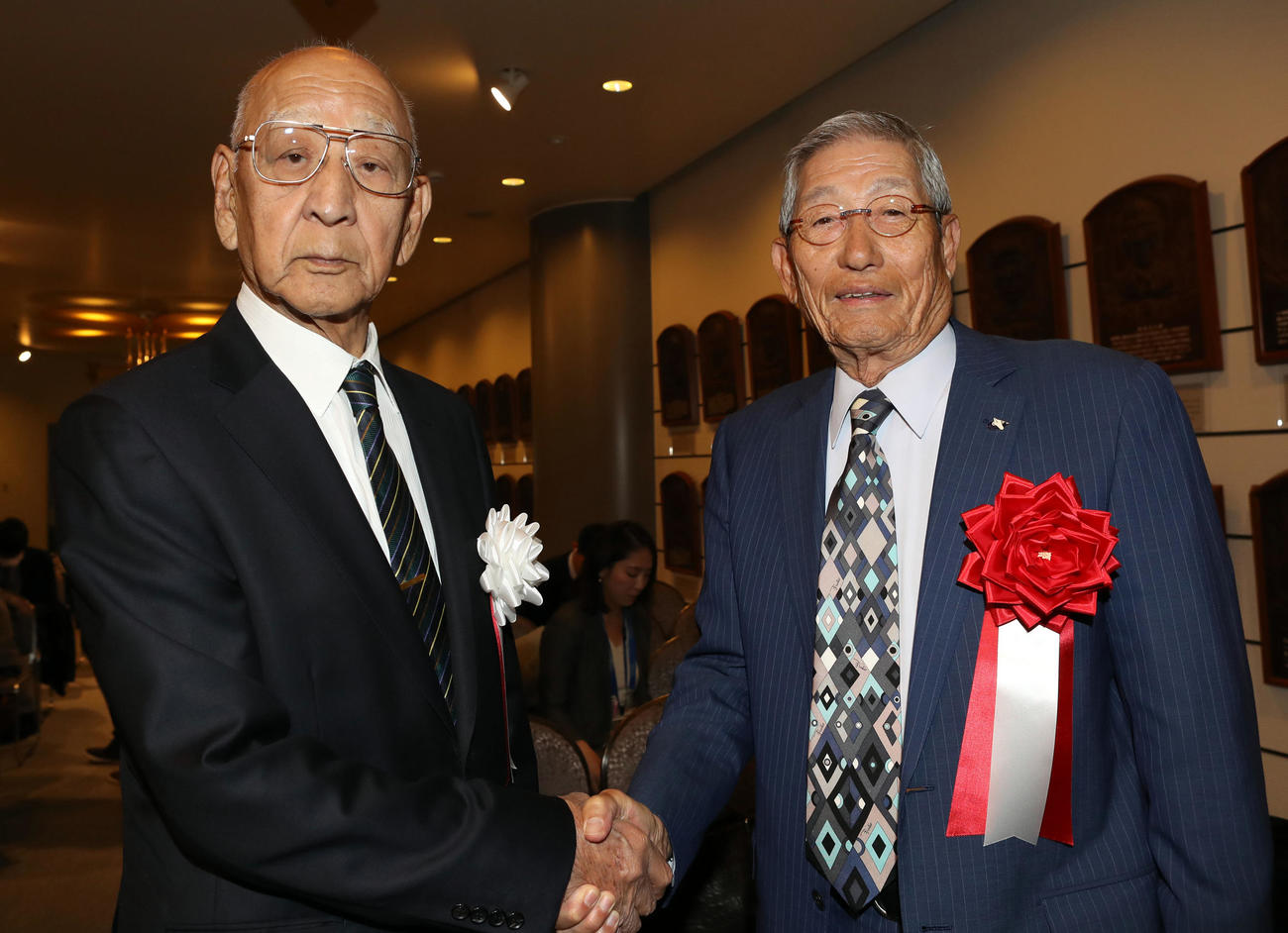 野球殿堂入り通知式で、祝辞を述べた杉下氏（左）と握手を交わす権藤氏（2019年1月15日撮影）