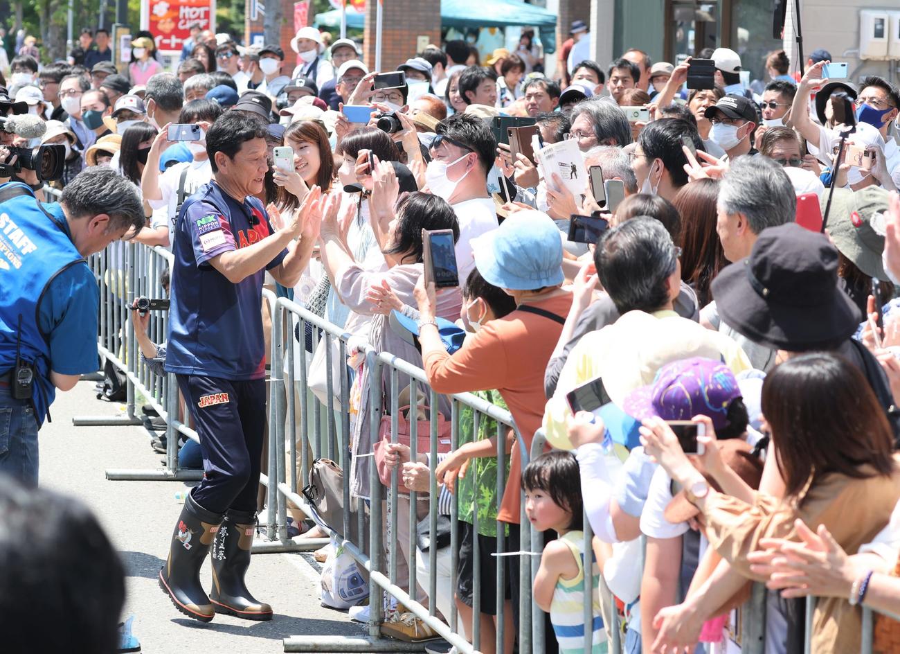 「栗山監督優勝パレード」で沿道の観衆とタッチする侍ジャパン栗山英樹前監督（撮影・黒川智章）