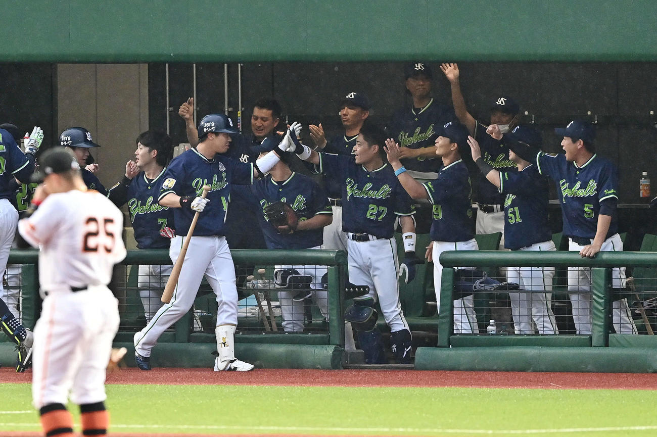 巨人対ヤクルト　3回表ヤクルト1死二、三塁、先制3点本塁打を放った山田（手前左）は生還しチームメートとタッチをかわす（撮影・滝沢徹郎）