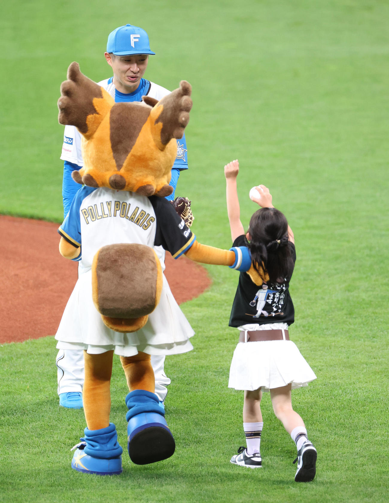 日本ハム対オリックス　試合前、日本ハム金子特命コーチは子どもからボールを受けとる（撮影・佐藤翔太）