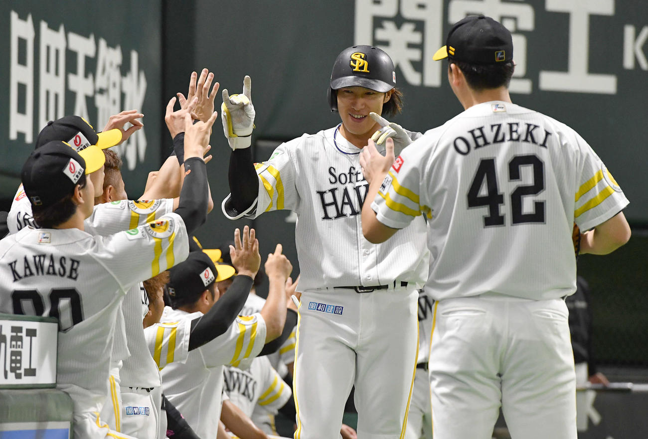 ソフトバンク対日本ハム　3回裏ソフトバンク2死二塁、先制の右越え2点本塁打を放ち、きつねポーズでタッチを交わす柳田（撮影・岩下翔太）